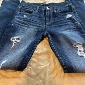 Express Women’s Skinny Jeans in Dark Blue Distressed Wash.